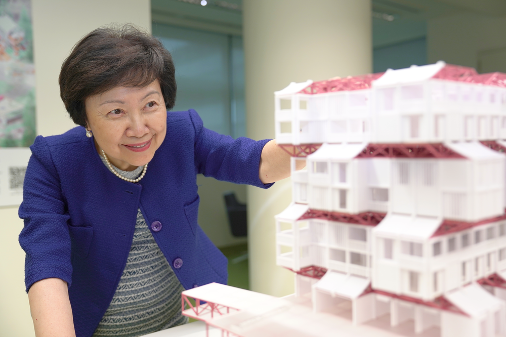 Cheong Koon Hean looking at a building model