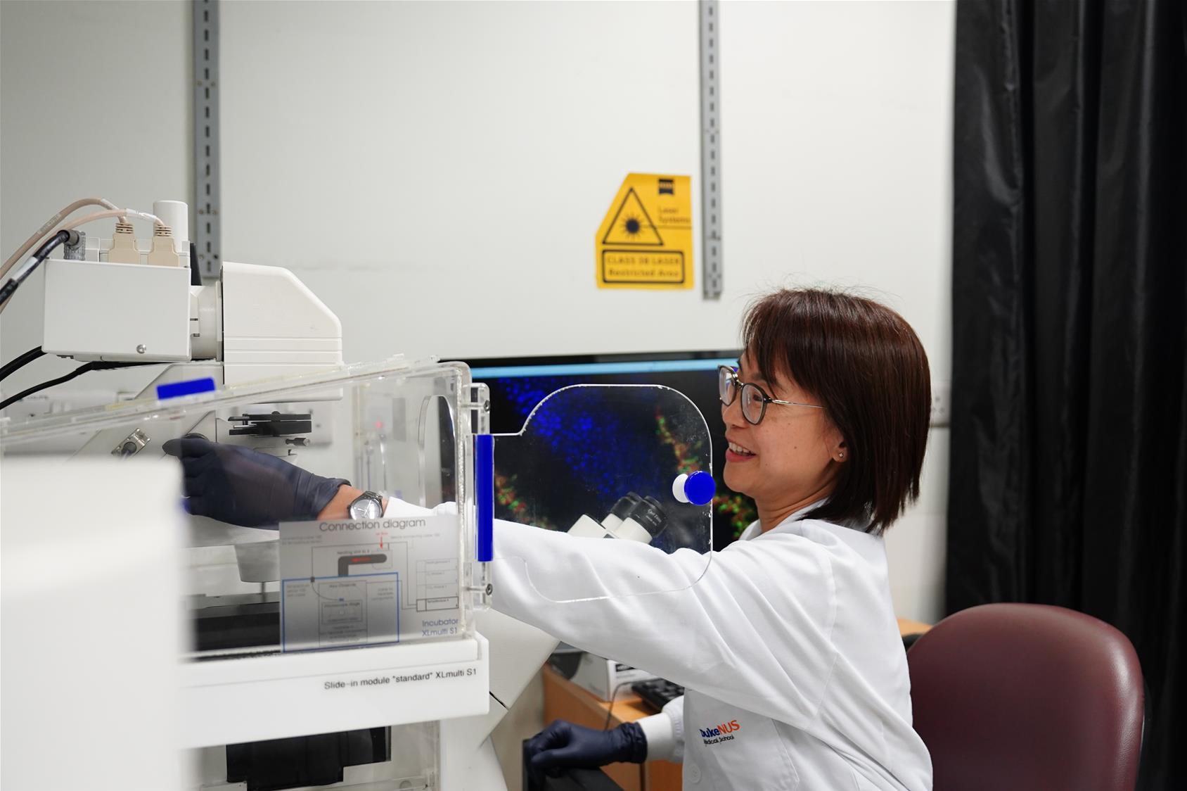 Tay in the Duke-NUS confocal microscopy room, where she often captures precise images of the retina. // Credit: Norfaezah Abdullah, Duke-NUS