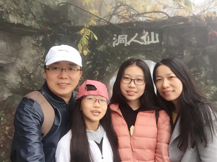Wang (right) with Yu (left) and their two daughters on a holiday in 2018