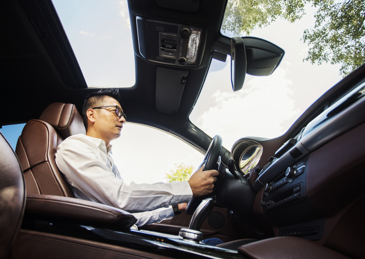 Stock photo of an Asian man driving