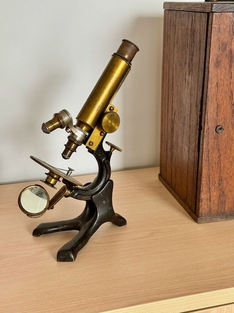 A photo of a brass antique microscope