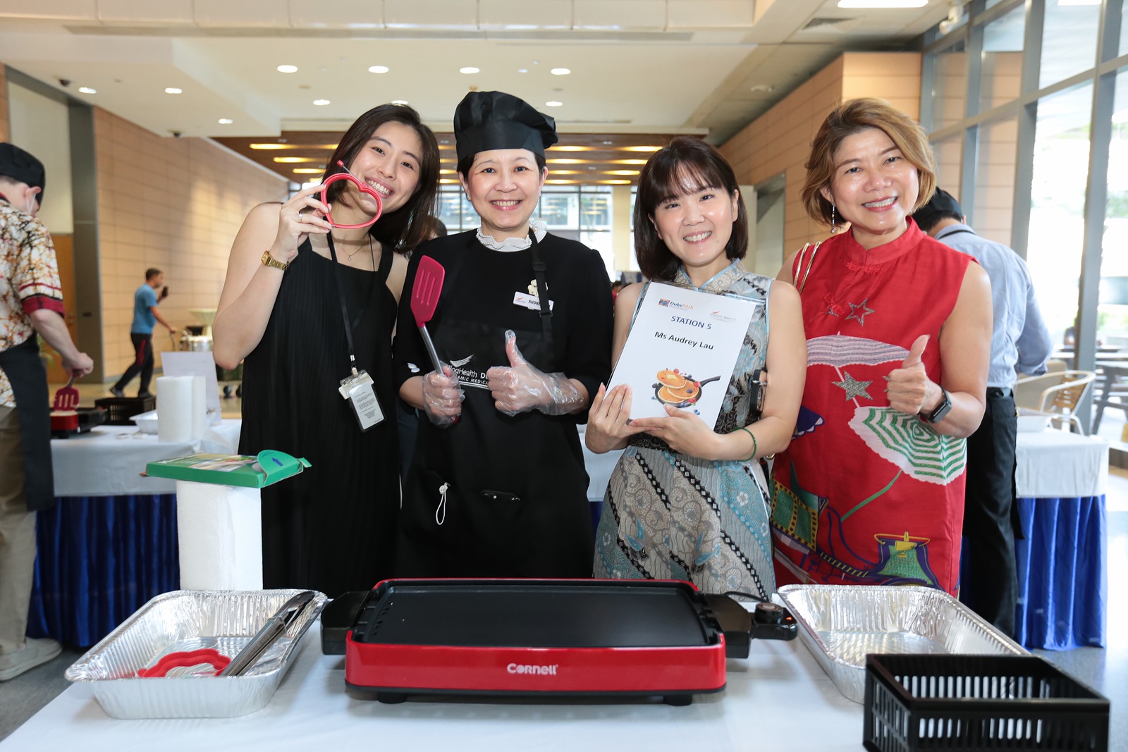 SingHealth’s Ms Audrey Lau poses with pancake enthusiasts and station supporters at the start of the feeding frenzy.