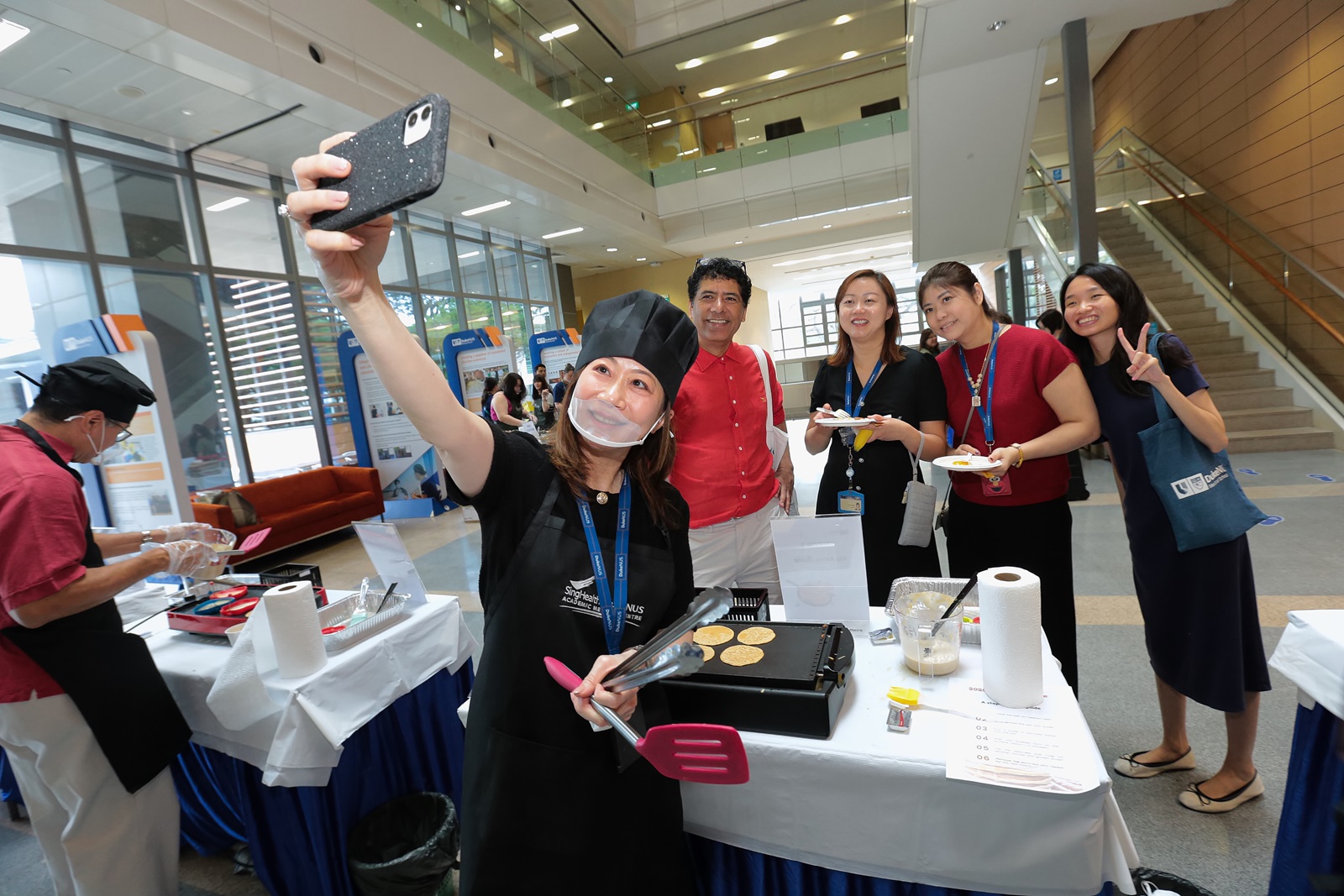 Ms Karen Chang snaps a quick shot commemorating her four pancakes with four hungry pancake lovers behind her.