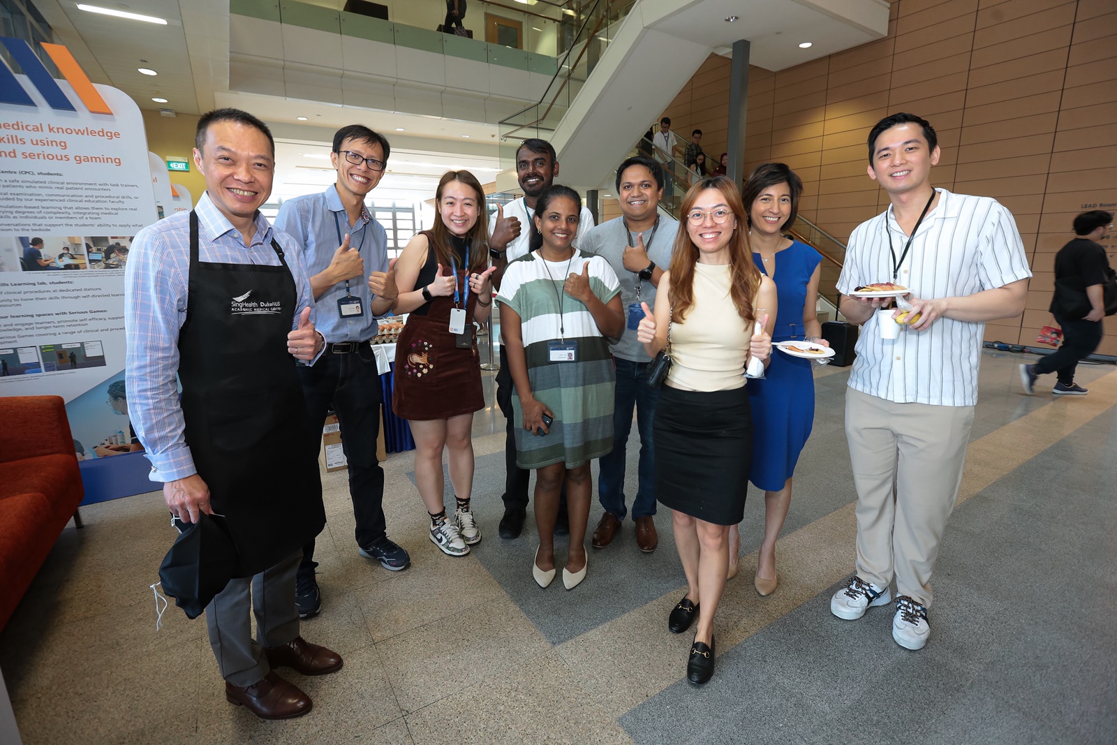 Associate Dean of Early Research Career Development, Professor Ooi Eng Eong of Emerging Infectious Diseases, takes a break from flipping batter to pose with his team.