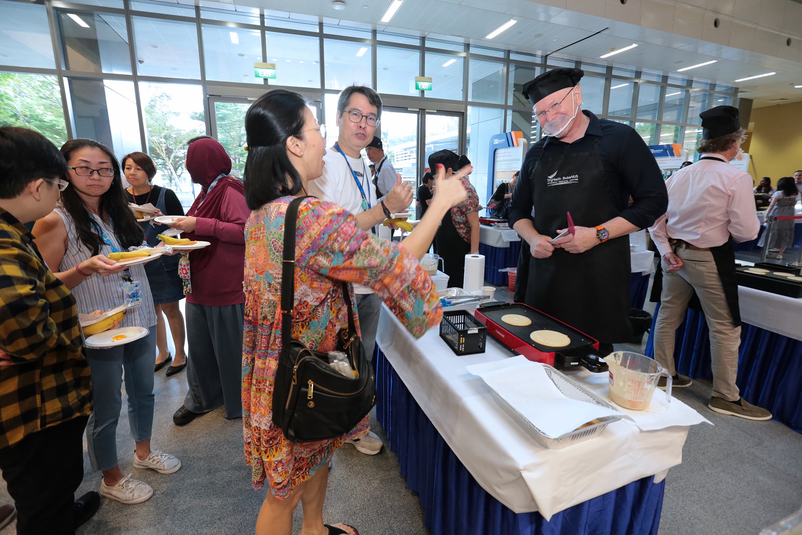 Senior Associate Dean of Medical Education, Professor Scott Compton, fields some spirited requests while in his apron.