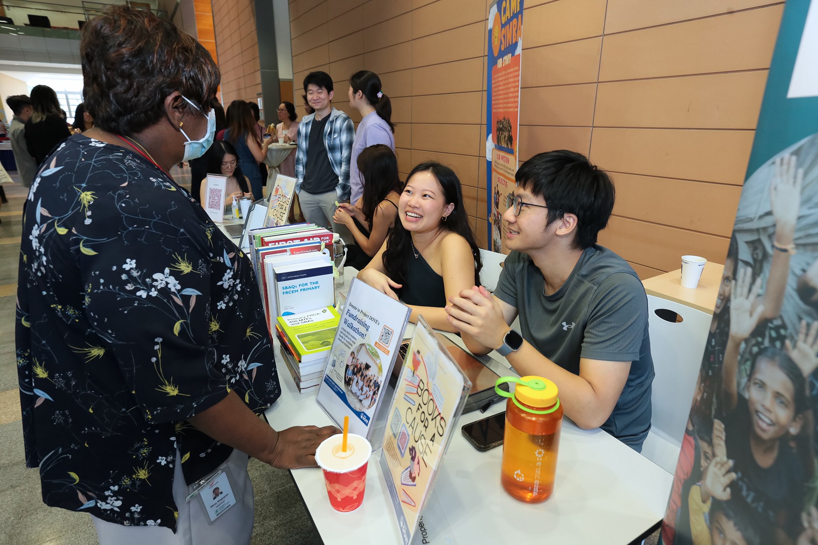 Project DOVE (short for Duke-NUS Overseas Volunteering Expedition), a student-led overseas medical mission, explaining what they do to interested onlookers.