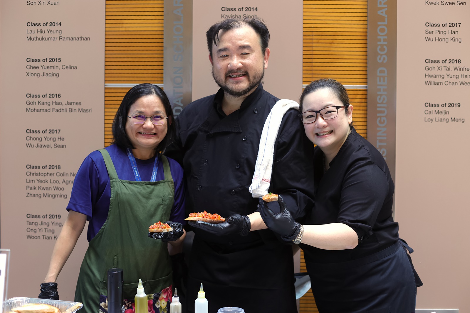 Dr Suzanne Goh (right) with the delectable chef-standard smoked salmon crostini station, a highlight of every year’s Pancake Day.