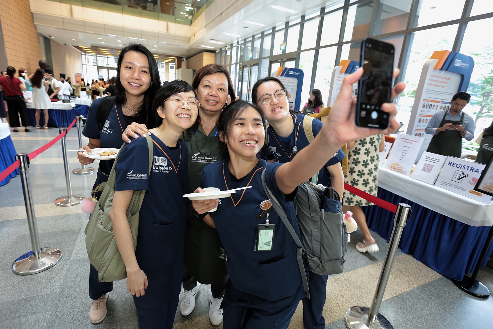 Student Affairs’ Mary Ng takes a selfie with some Duke-NUS students in their scrubs, excited to taste some home(school?)-made pancakes.