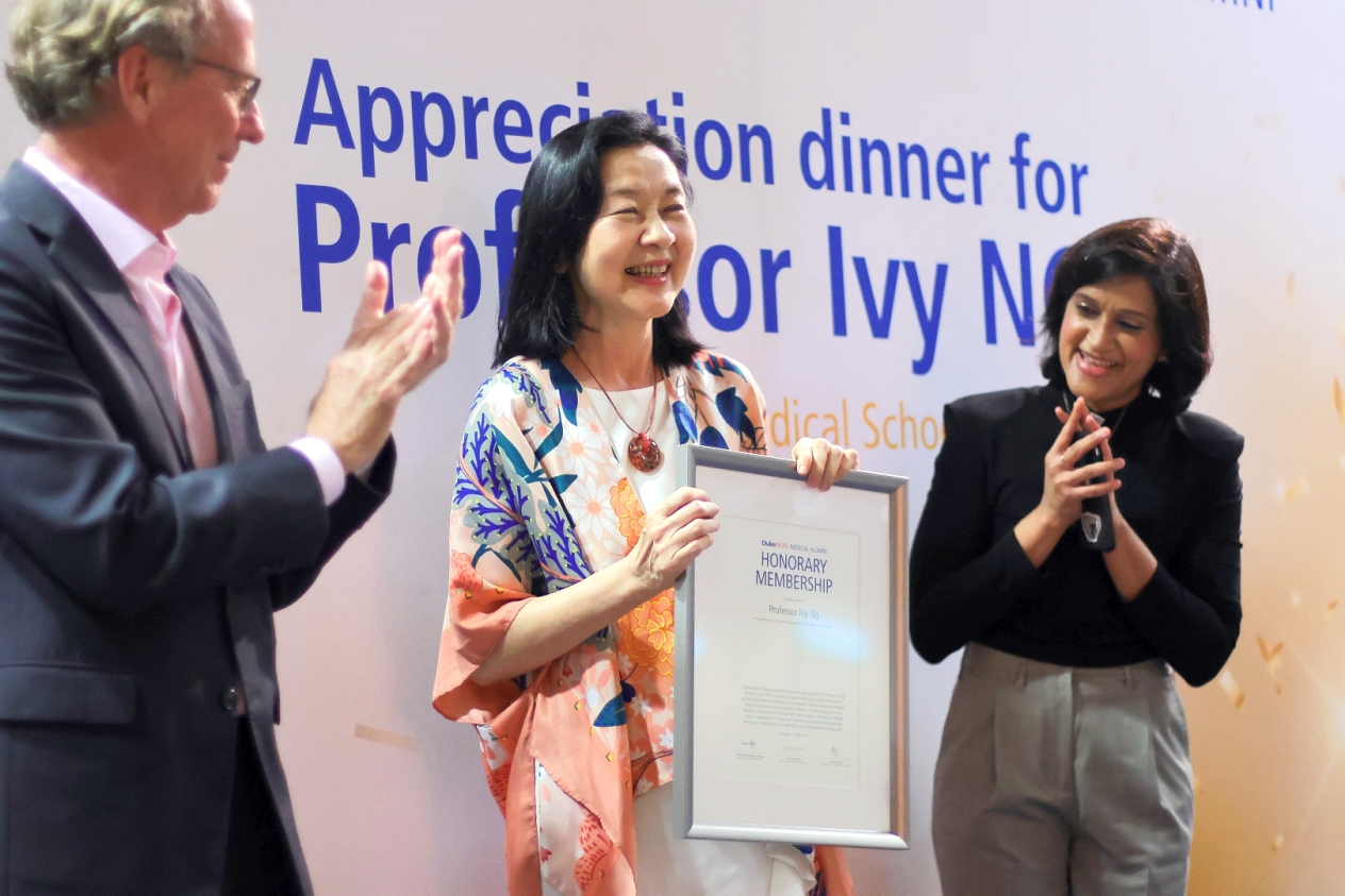 Prof Ng (centre) and Dean Coffman (left) with Dr Pandey (right) on stage as she is presented with the DNMA honorary membership