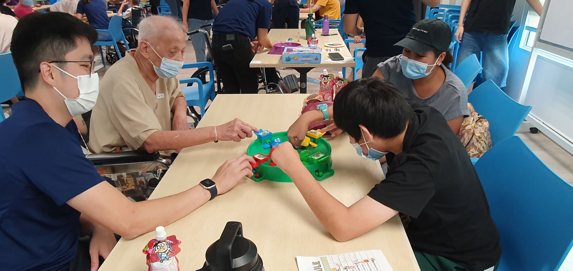 Four individuals of different ages are playing a game