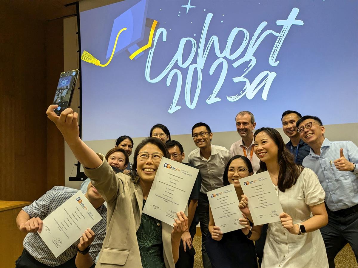 The attending graduates of the 2023a cohort gather for a selfie with their certificates. // Credit:  Nicole Lim, Duke-NUS